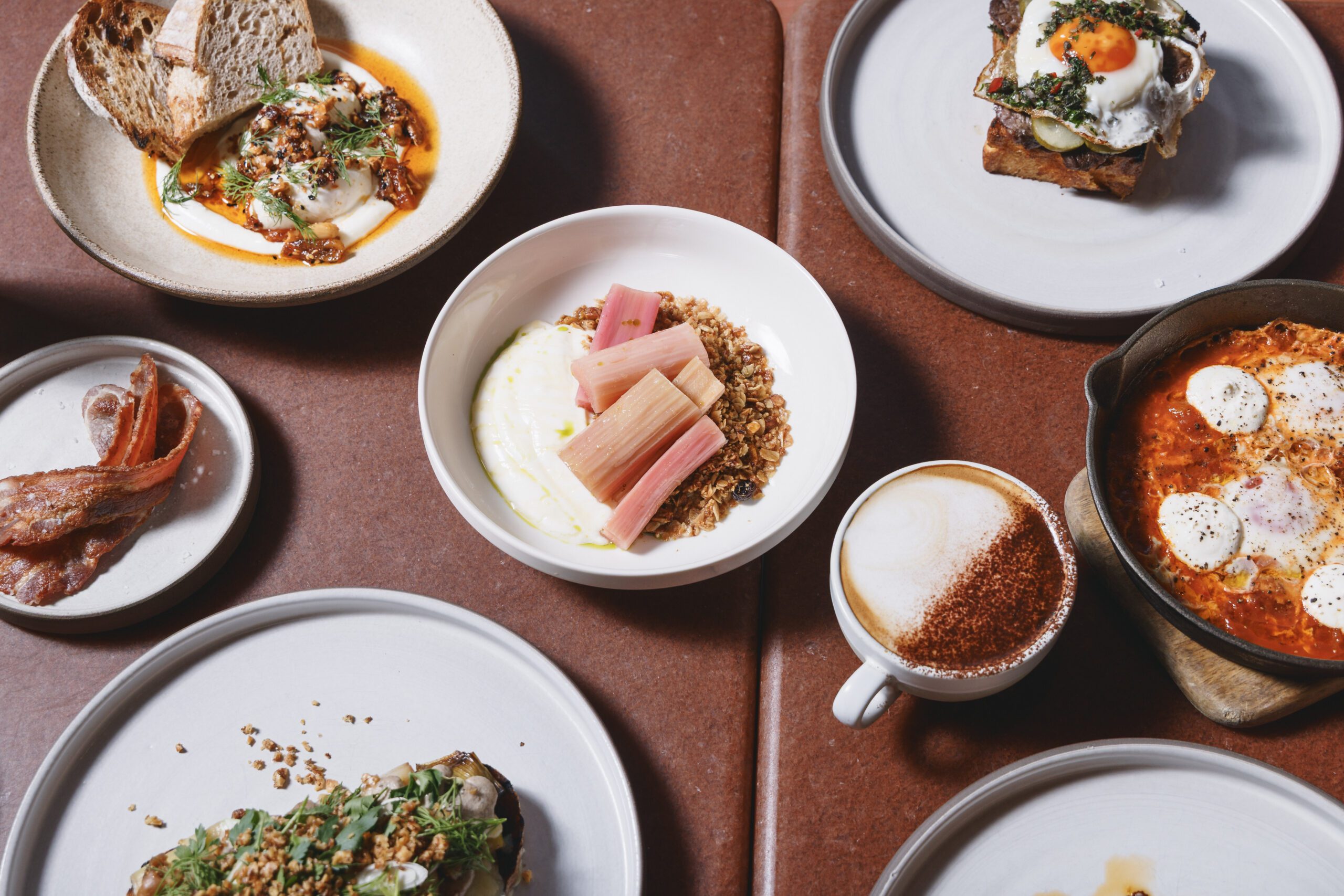 All-day breakfast plates, with eggs, sourdough toast, granola, coffee at Ara Restaurant, East London