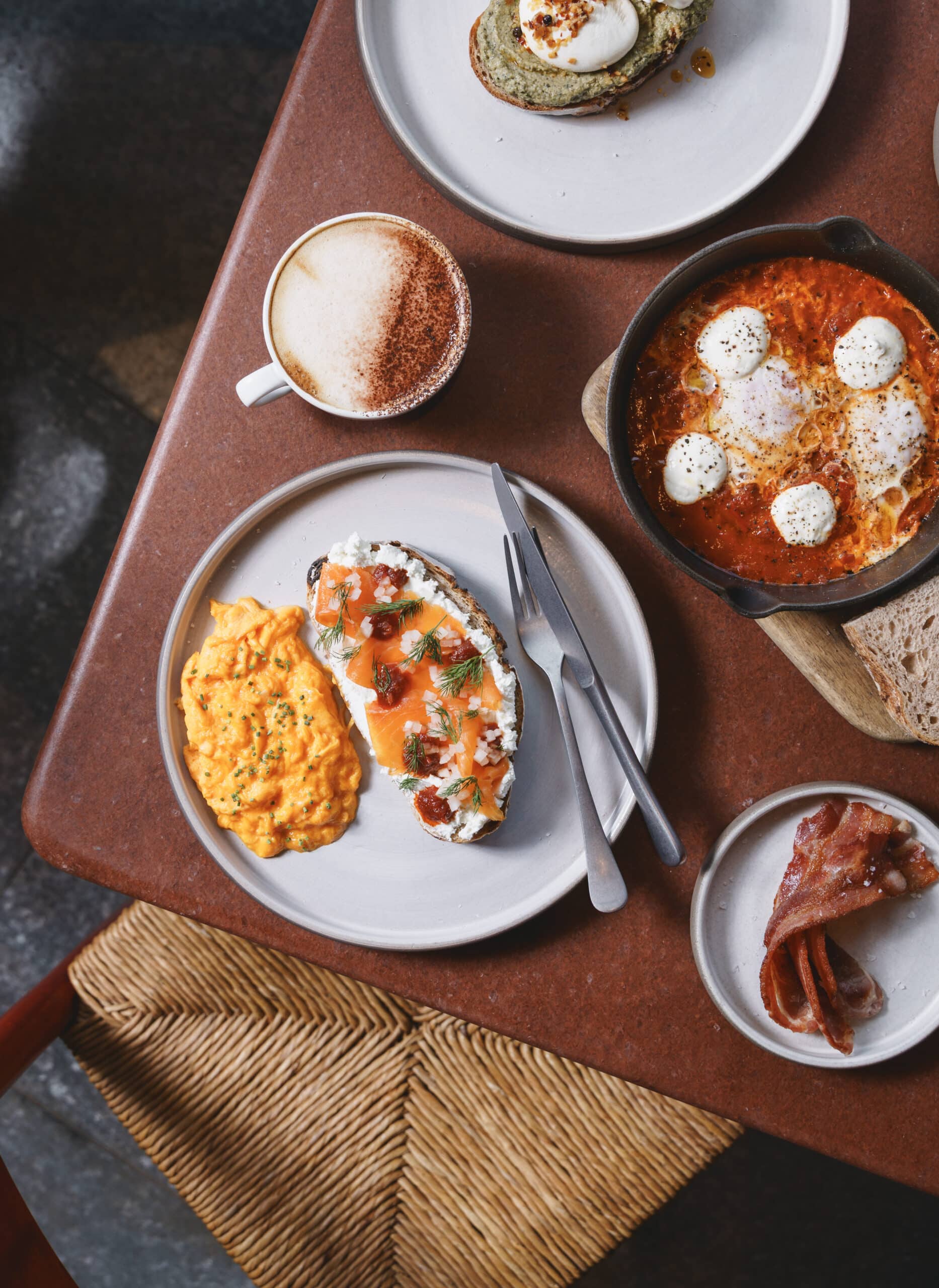 Smoked trout toast with creamy labneh, dill, and tomato chilli jam, served alongside soft scrambled eggs at Ara Restaurant in Aldgate East, Brick Lane.