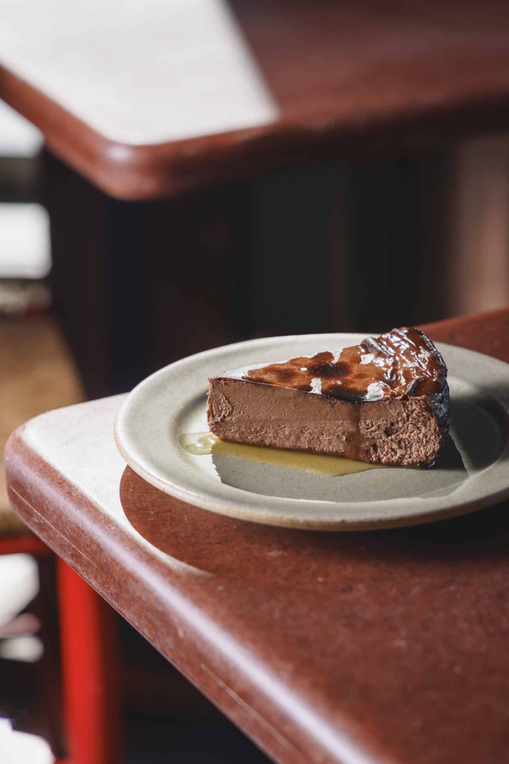 Basque chocolate cheesecake topped with glossy whey caramel, made using leftover whey from labneh or house-made butter at Ara in Aldgate East.